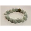 Image 2 : ONE ELASTICISED BRACELET OF 16 PALE GREEN JADE BEADS.  APPROX. 19CM LONG.  REPLACEMENT VALUE: