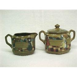 Buffalo Pottery Deldare Ware creamer and covered sugar, both Scenes of Village Life in ye olden d...