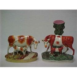 Two Staffordshire figurines including spill, cow with calf, 11 1/4'' high, crazing; and a figurin...