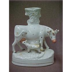 Staffordshire figural spill, Cow with calf, measures 10 3/4  high, mid 19th C. Estimate 300/40...