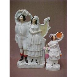 Two Staffordshire figurines including double figurine of standing man with accordian and standing...