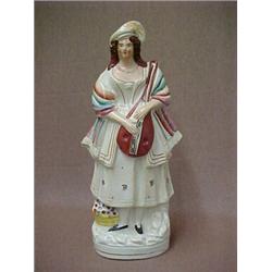 Staffordshire figurine of woman with mandolin (chip on edge of scarf) measures 14" high, mid 19th...