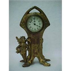Gilt metal cased Art Nouveau figural dresser clock by New Haven Clock Company, stylized floral de...