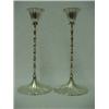 A pair of sterling silver weighted candlesticks, fluted candleholders over leaf shaped decoration...