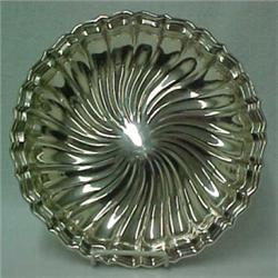 Sterling silver round serving tray, fluted rim with swirled center decoration, measures 12" diame...
