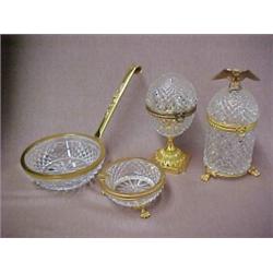 Four piece cut crystal and brass smoking set including cigarette holder with hinged lid, eagle fi...