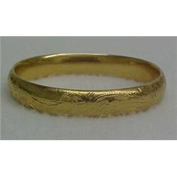 14K gold bangle bracelet, yellow gold bangle bracelet with engraved decoration, measures 3/4" wid...