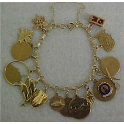 14K gold charm bracelet and charms, 7 1/2" charm bracelet with thirteen 14K gold charms and two g...