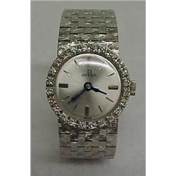 Lady's 18K white gold and diamond wrist watch, 18K white gold watch and flex band, face is surrou...