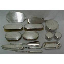 Thirteen piece sterling silver dresser set, C. 1915 dresser set with scroll and leaf design compr...