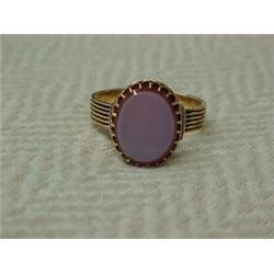 Victorian rose gold and agate ring, oval shaped prong set orange banded agate with ridged band, a...