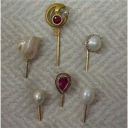 Six gold stickpins, includes 14K gold filigree with pear shaped red stone; round with red stone a...