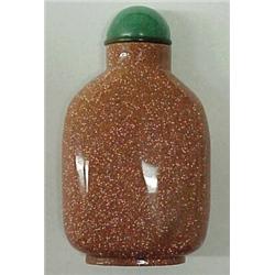 Goldstone snuff bottle, 2 3/4" high, undecorated carved goldstone with green stone stopper, with...