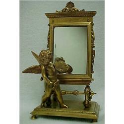 Bronze dresser piece depicting cupid with artist's palette at chevel mirror, hinge on bottom of m...