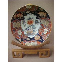 Chinese Imari bowl on stand, center decoration with chrysanthemum in planter, surrounded by flora...