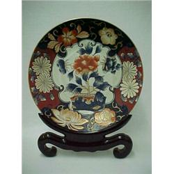 Chinese Imari charger on stand, center decoration with chrysanthemum in planter surrounded by sty...