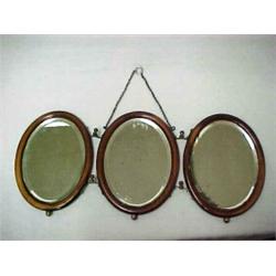Oval triple shaving mirror, three oval beveled glass mirrors in walnut frames with hinged brass f...