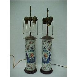 A pair of Chinese Export porcelain lamps, each in cylinder form, depicting four men holding two g...