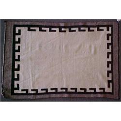 Navajo rug, grey border with dark brown geometric edge design on white center field, early 20th C...
