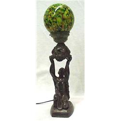 Spelter figural lamp with art glass shade, round art glass globe on metal lamp depicting kneeling...