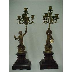 A pair of French Victorian figural candelabrum, each candelabra with five candleholders being hel...