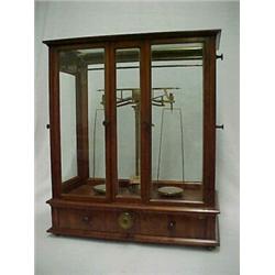 Apothecary or Jeweler's scale in walnut case, rectangular case with two glass doors on front, fla...