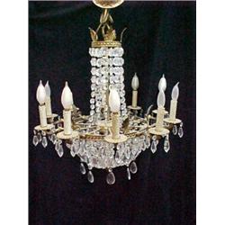 Round brass chandelier with cascading cut glass prisms, and ten arms radiating out from center ax...