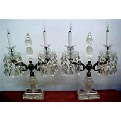 A pair of cut crystal double candle lamps, center cut finial on gilt metal stem with two arms, ea...