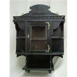 Painted walnut Victorian hanging what not shelf, carved crest and gallery over single beveled gla...