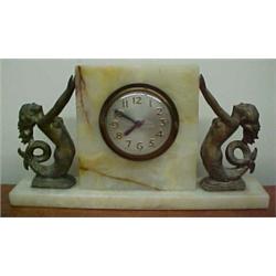 Sessions alabaster cased electric clock, square case flanked by spelter mermaid on each side, on...