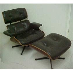 Brown leather armchair and ottoman with black walnut shell, and cast aluminum bases, made in the...