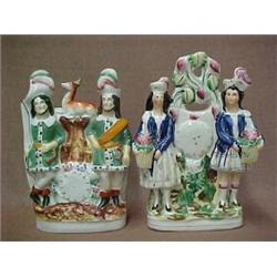 Two Staffordshire double figurines, one with man and woman with flower baskets...