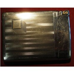 803. Very unusual cigarette case with built-in lighter that flips open when case is closed. Marked R