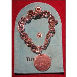804.Tiffany & Company HEAVY link bracelet with round “Return to Tiffany & Co.” tag. In suede Tiffany