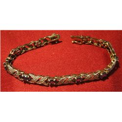 816. Sterling silver bracelet with purple stones (tanzanite?). Very bright and pretty, classy, dress