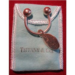 820. Tiffany & Company screw ball key chain with an oval “Return to Tiffany & Co.” tag. In suede Tif