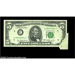 Fr. 1974-C $5 1977 Federal Reserve Note. About Uncirculated.A nice foldover error that is missing th