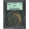 1887 S$1 MS65 PCGS. The obverse has vivid bands of gold, violet, and apple-green patina. The base of