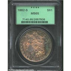 1882-S S$1 MS65 PCGS. Splendid aqua, lavender, and orange-gold patina. A boldly struck Gem that is b