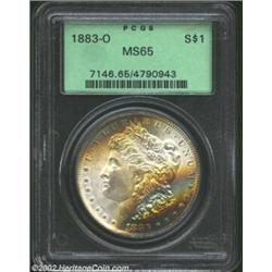 1883-O S$1 MS65 PCGS. Bands of gold, powder-blue, violet, and aqua patina interchange across the obv