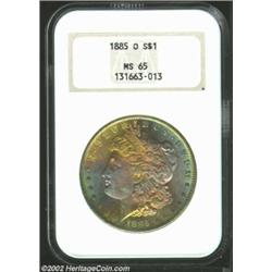 1885-O S$1 MS65 NGC. Exceptionally toned with vivid blushes of lemon, lavender, and electric-blue pa