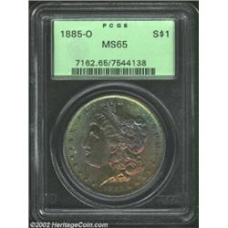 1885-O S$1 MS65 PCGS. The obverse has deep orange-gold, rose, and navy-blue patina. A well struck an