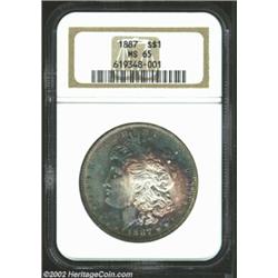 1887 S$1 MS65 NGC. Gorgeous powder-blue patina, with a ring of golden-violet color on the obverse. S