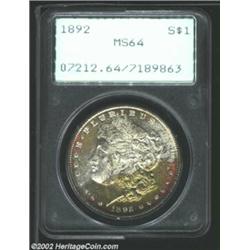 1892 S$1 MS64 PCGS. The obverse has spectacular champagne-rose, sea-green, and silver-gray patina, w