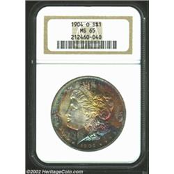 1904-O S$1 MS65 NGC. Orange, violet, and navy-blue patina. Boldly struck and lustrous with carefully