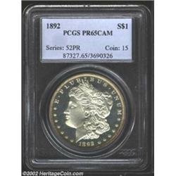 1892 S$1 PR65 Cameo PCGS. Moderate golden-orange rim toning interrupts the otherwise brilliant sheen