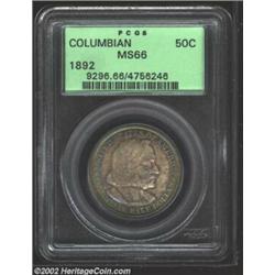 1892 50C Columbian MS66 PCGS. Both sides are deeply toned in shades of lavender and iridescent-blue.