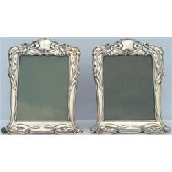 Pair of Edwardian HM silver strut photograph frames with repousse irises...