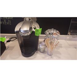 KEURIG COFFEE MACHINE WITH METAAL POD HOLDER, GLASSES WITH STIR STICKS, AND SURGAR