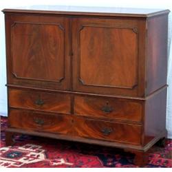 C18th George III mahogany low linen press with panelled doors enclosing 3...